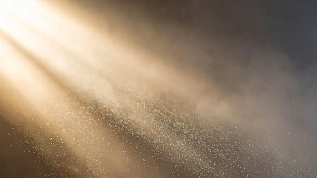 Dust floating in a beam of light, showing how stale air can reveal simple signs your workshop is not ready to start woodworking.