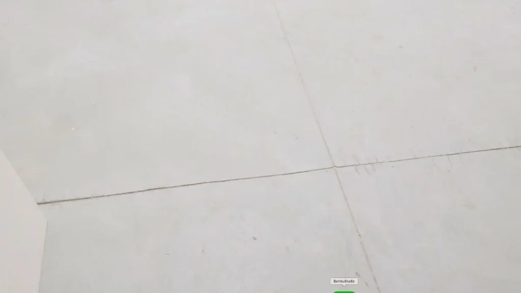 Bare concrete floor with visible joints in a woodworking shop, showing a basic woodworking shop floor type.