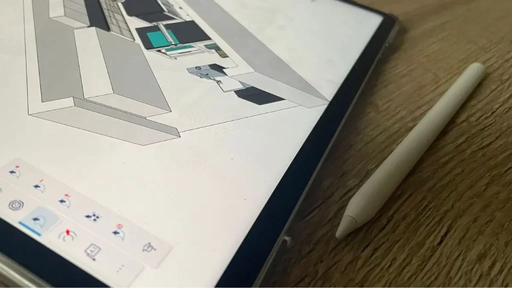 Sketching a DIY woodworking jig design on an iPad using a stylus for precise planning.