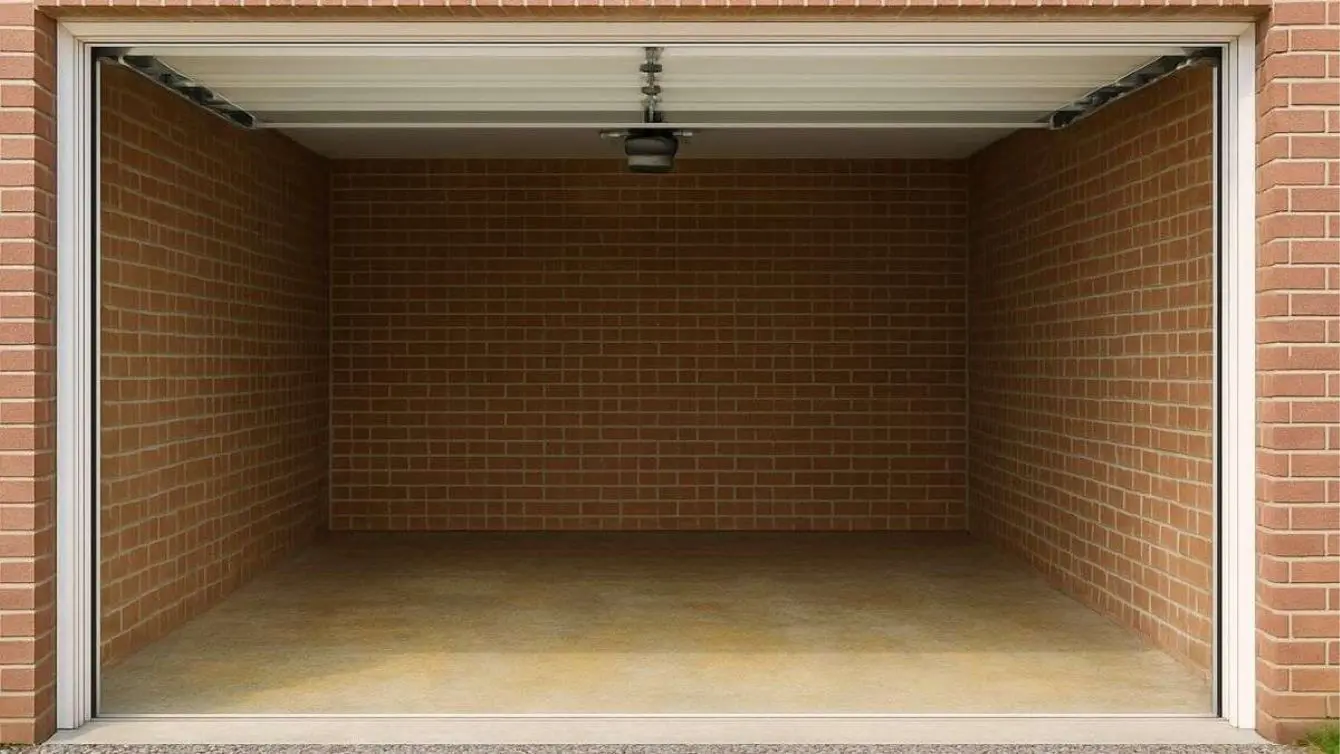 Empty one car garage ready to be turned into a Woodworking Shop Space.