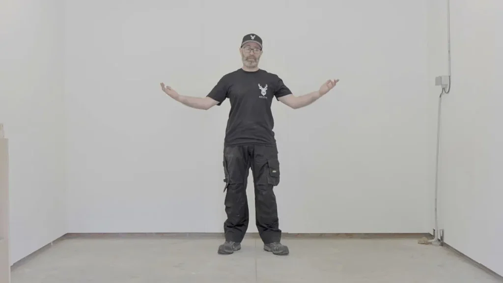 Christophe from Ash Stag Woodworking standing in an empty room while showing the size of a potential Woodworking Shop Space.