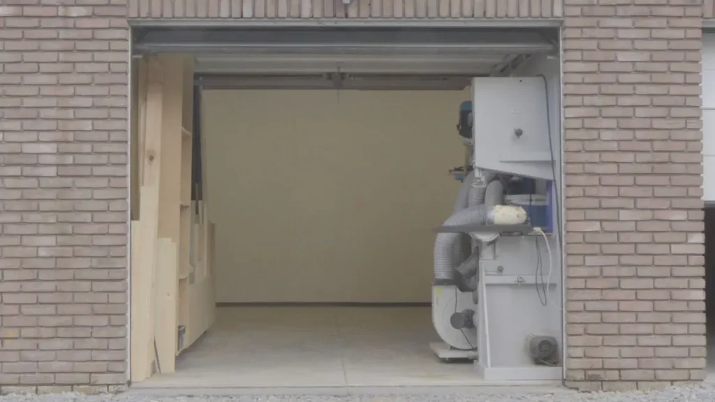 One-car garage prepared for a woodworking shop layout with clear floor space for tools and workflow.