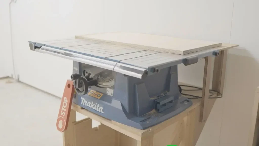 Compact table saw setup in a small woodworking shop with a clean and organized layout.