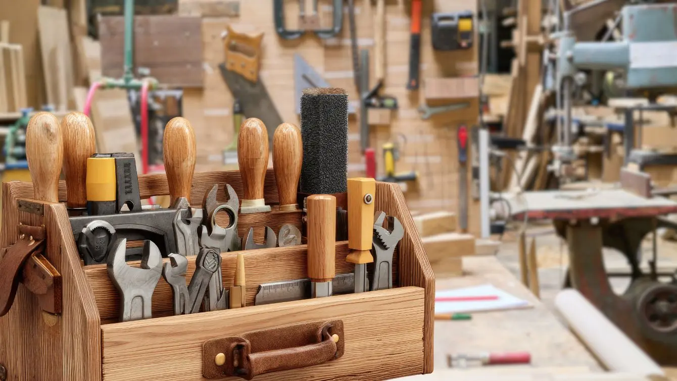 Wooden toolbox filled with essential hand tools in a workshop, showing a practical starting point for Woodworking Tools for beginners.