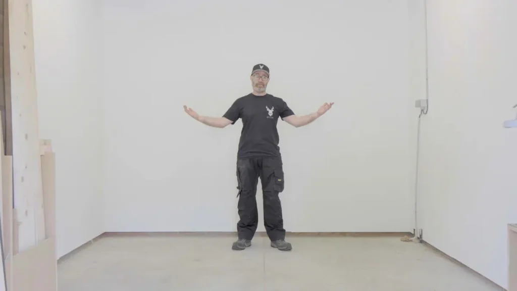 Standing in an empty single-car garage workshop, woodworking for beginners in small spaces.