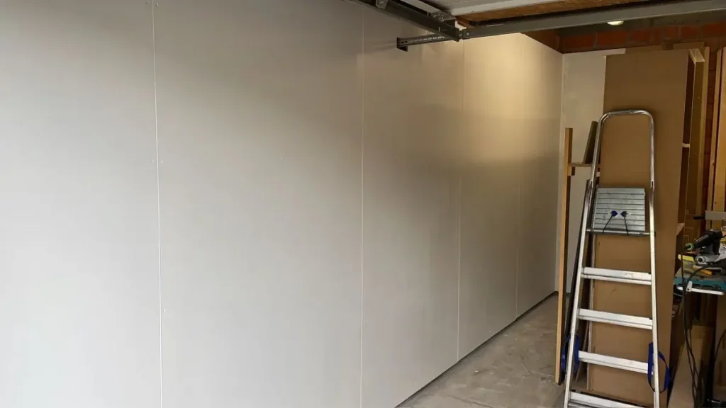 White MDF workshop walls painted for better light and clarity