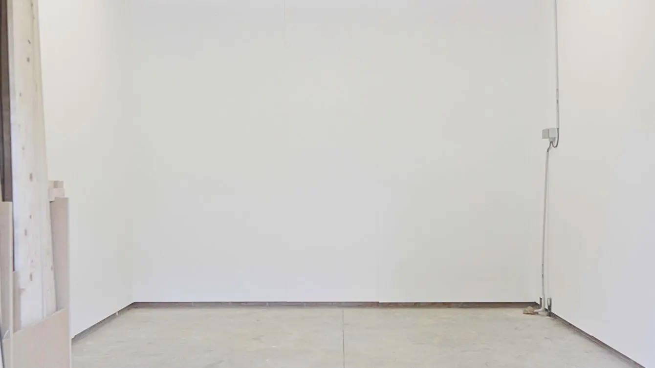 Finished white workshop walls in a small garage woodshop