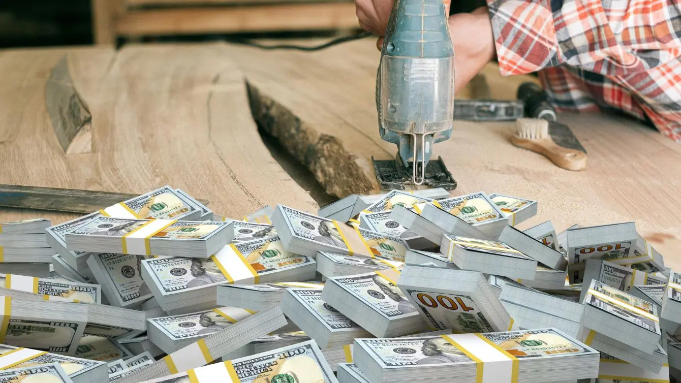 Stacks of cash on a workbench with a power tool, illustrating how much does it cost to start woodworking and why beginners often overestimate it