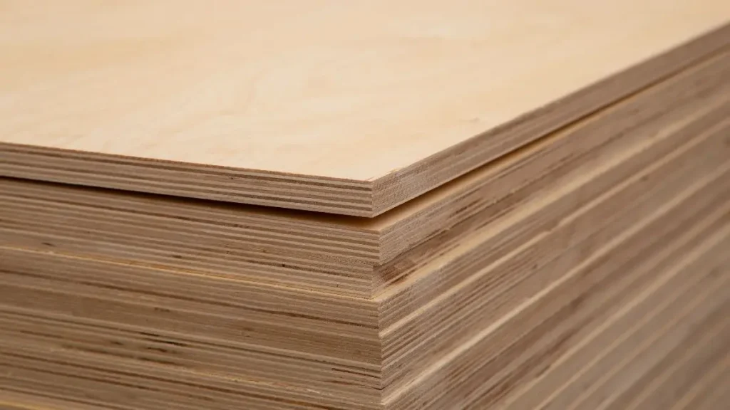 Stack of plywood sheets ready to be used as a workshop flooring layer.