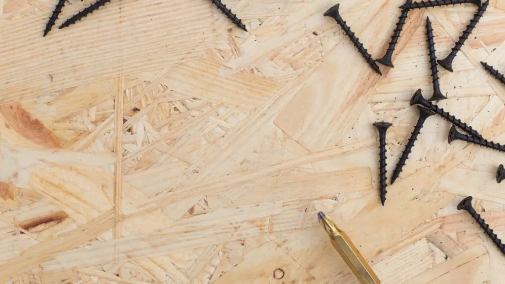 Close up of screws on an OSB surface showing how OSB workshop walls hold fasteners.