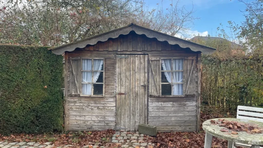 An old wooden garden shed used for woodworking without a shop in the early years